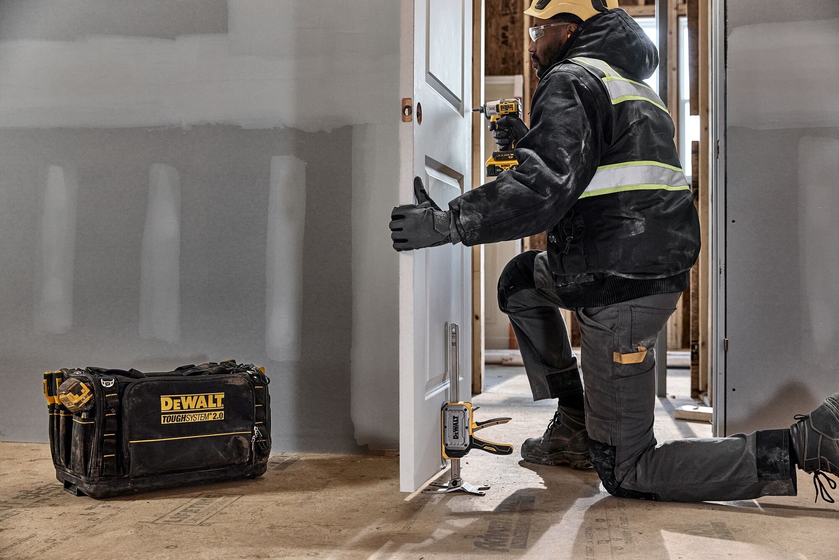 Worker leveling a door with DEWALT(R) TOUGHSERIES(TM) CONSTRUCTION JACK 