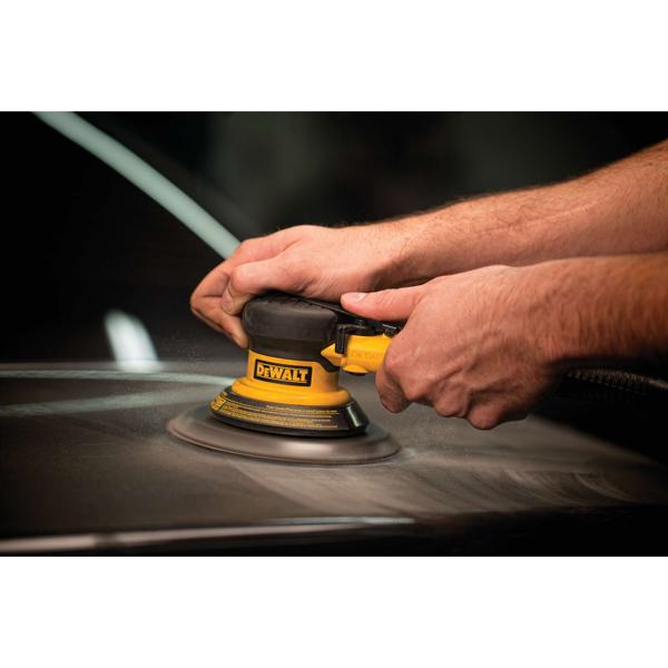 Quarter inch 90 P s i Touch control trigger pneumatic palm sander performing sanding.