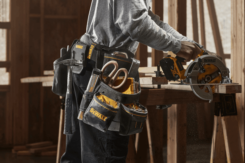 CONSTRUCTION WORKER WEARING DEWALT PROFESSIONAL IMPACT DRILL HOLSTER