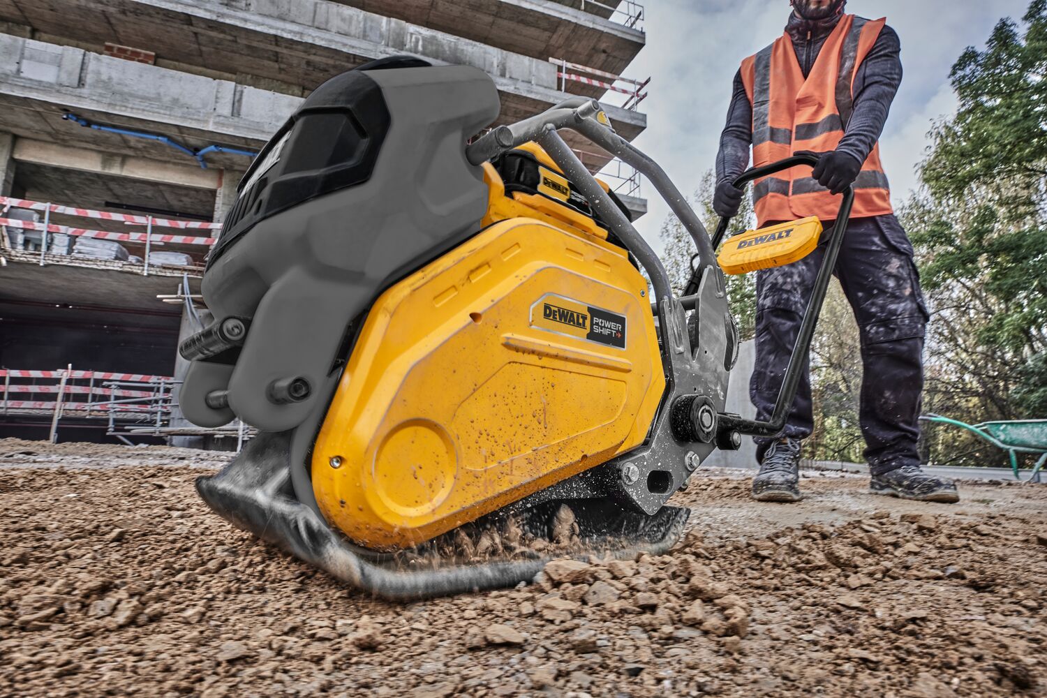 Man operating plate compactor