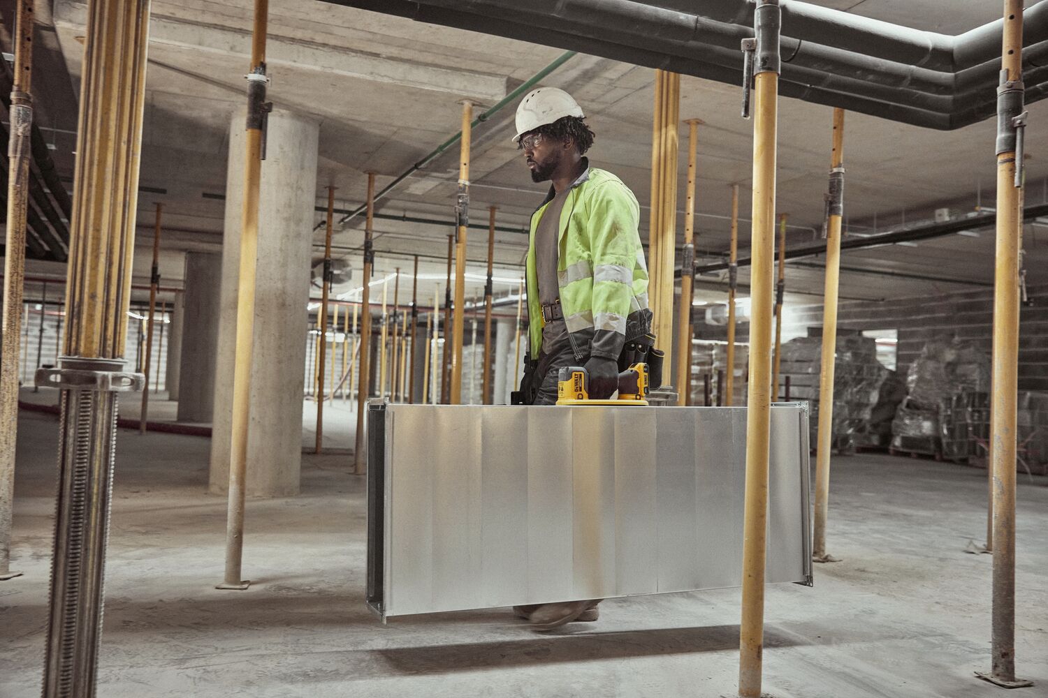 User lifting HVAC duck with DEWALT 20V MAX Grabo Lifter