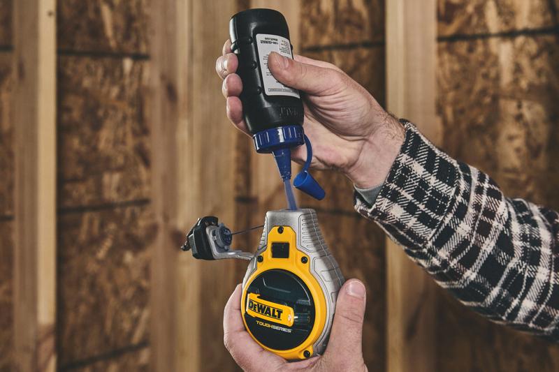 Putting blue chalk in the DEWALT TOUGHSERIES™ Chalk Reel