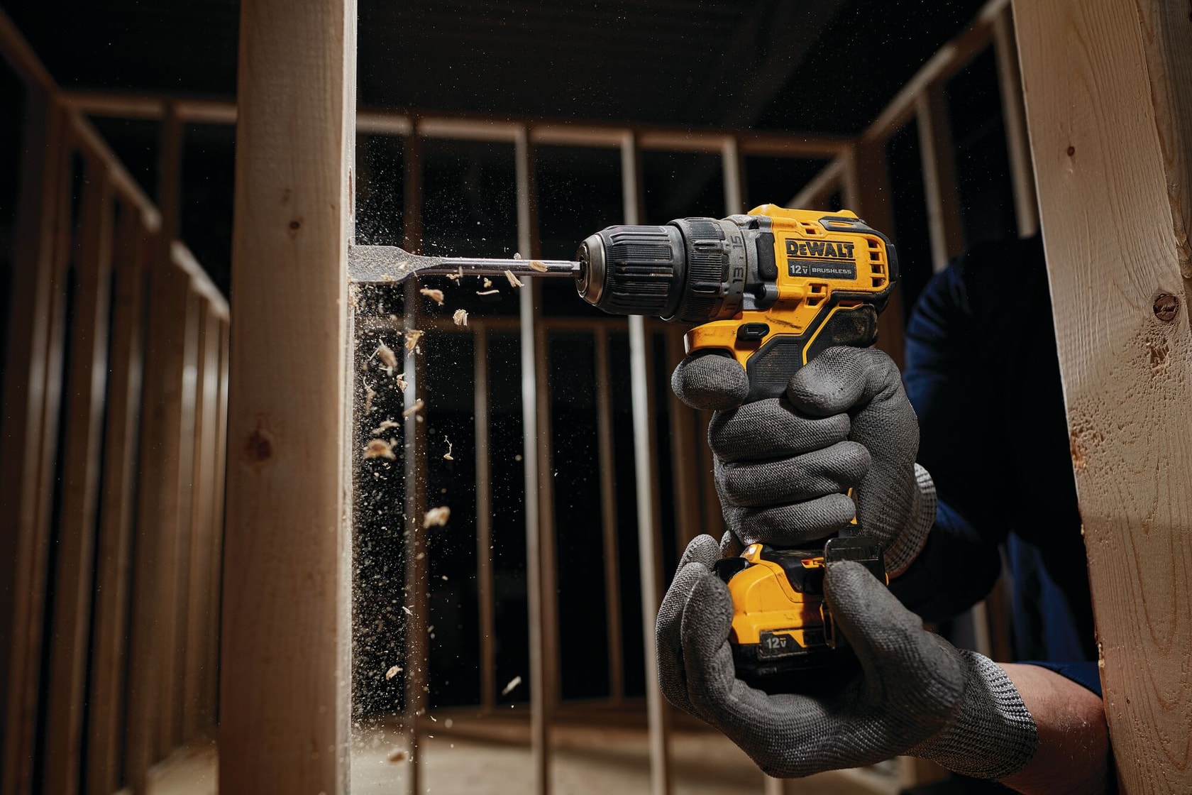 Brushless cordless drill driver with battery drilling  wooden frame.