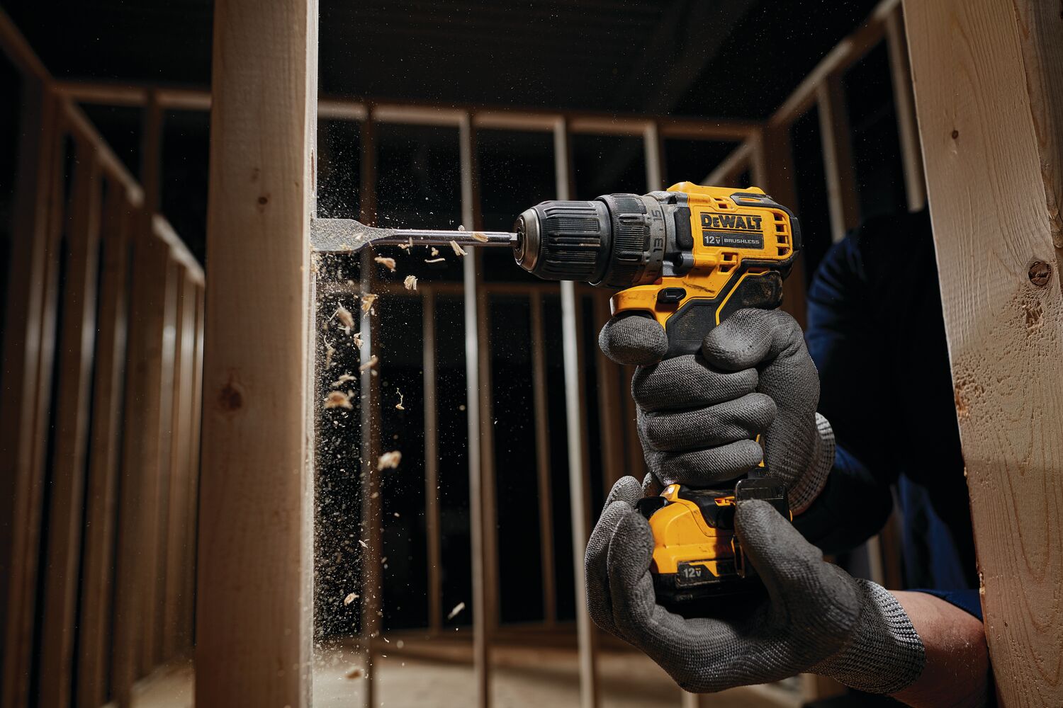 Brushless cordless drill driver with battery drilling  wooden frame.
