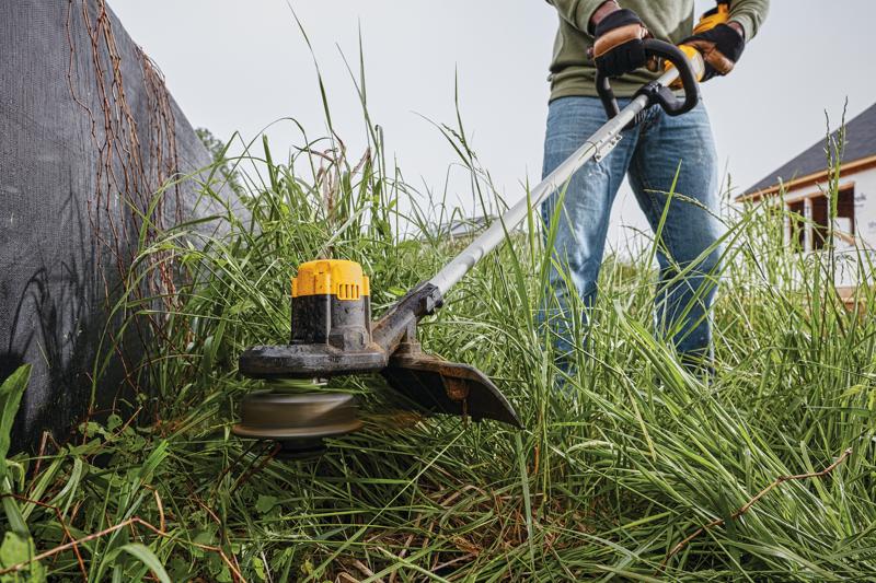 Cordless String Trimmer being used on plants.