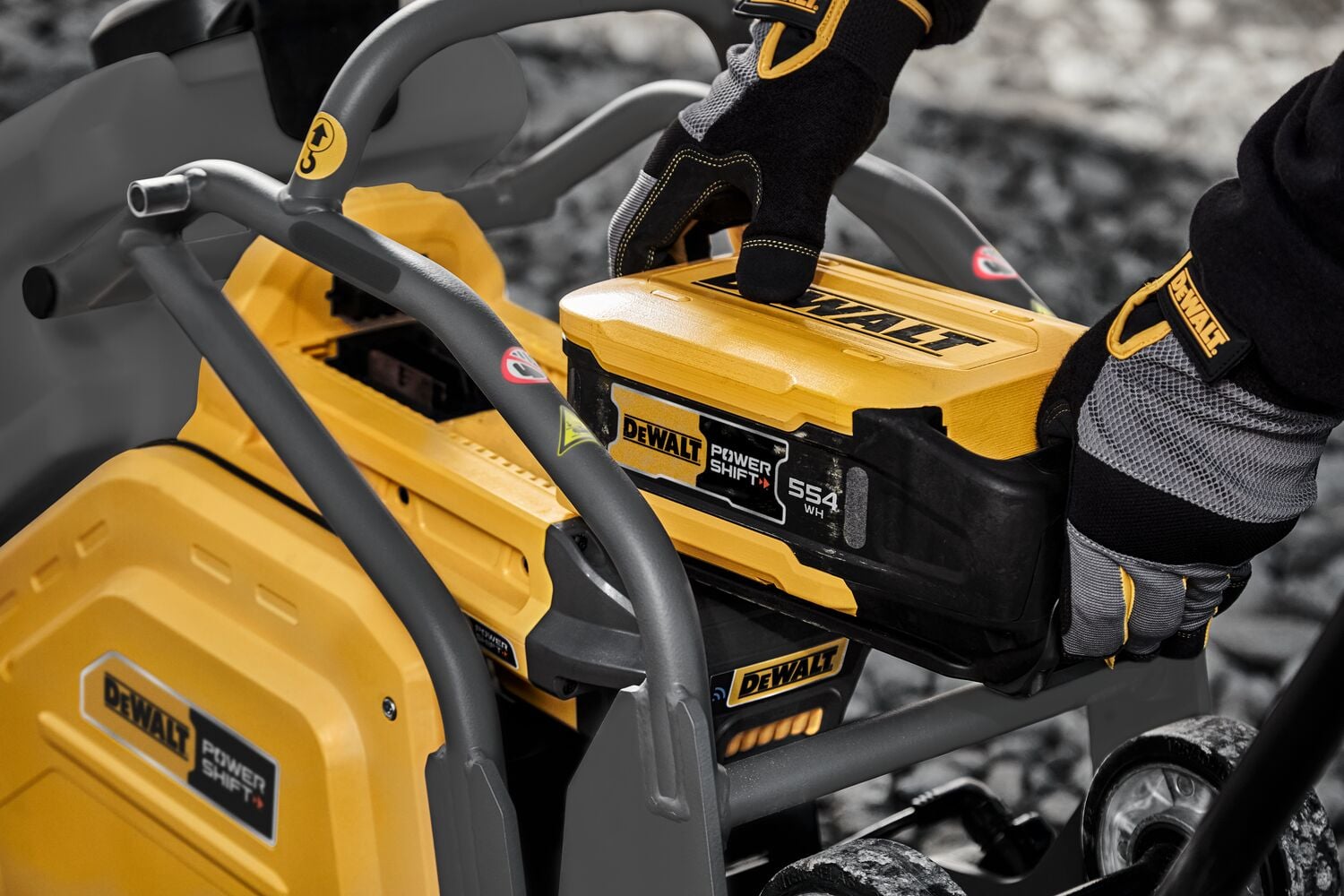 Man inserting battery into plate compactor