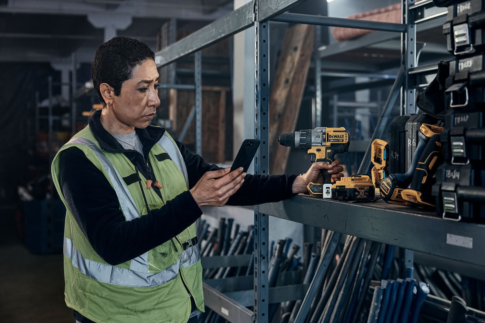 A woman is holding a DEWALT MATRIX™ Jig Saw Attachment for Cordless Drill.