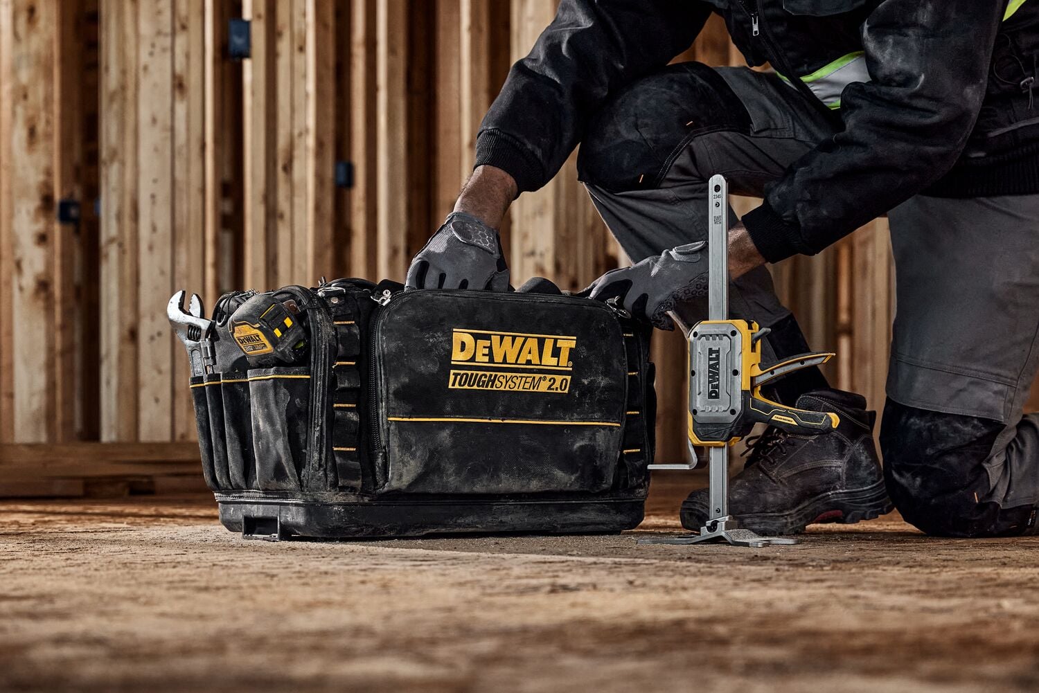 DEWALT(R) TOUGHSERIES(TM) CONSTRUCTION JACK sitting next to tool bag
